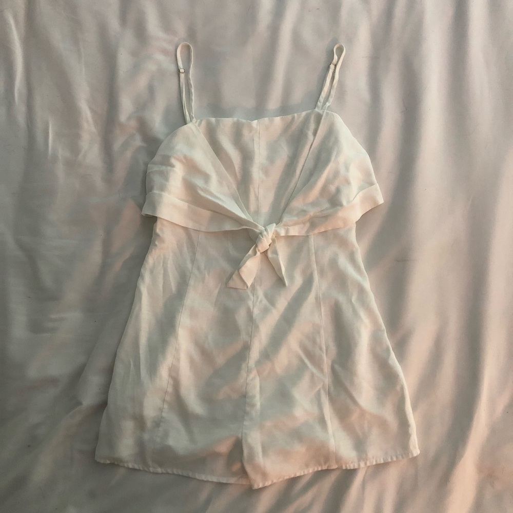 White romper with bow tied in front